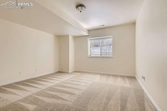 13968 Windy Oaks Road Colorado Springs, CO 80921 - Photo 23 of 34 a view of an empty room with a window