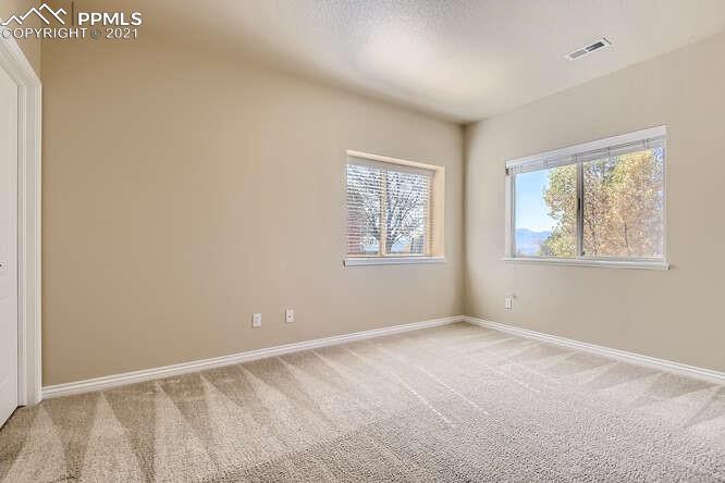 13968 Windy Oaks Road Colorado Springs, CO 80921 - Photo 24 of 34 an empty room with windows