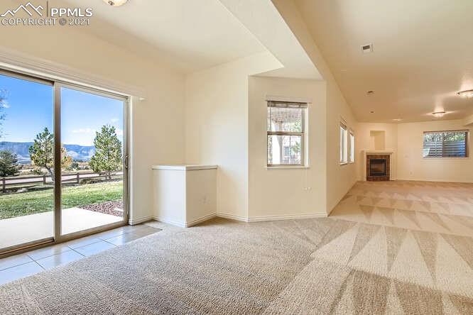 13968 Windy Oaks Road Colorado Springs, CO 80921 - Photo 29 of 34 a view of an empty room with wooden floor and a window