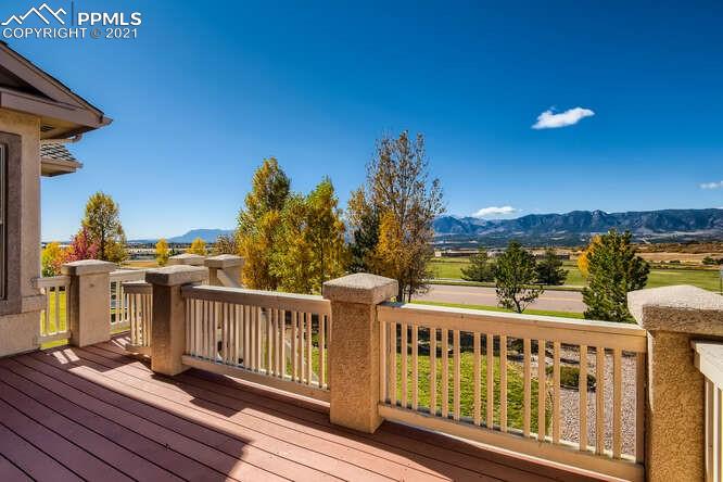 13968 Windy Oaks Road Colorado Springs, CO 80921 - Photo 32 of 34 a view of a balcony with wooden floor and fence