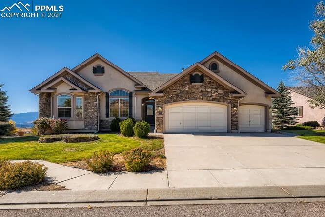 13968 Windy Oaks Road Colorado Springs, CO 80921 - Photo 6 of 34 a front view of a house with a yard