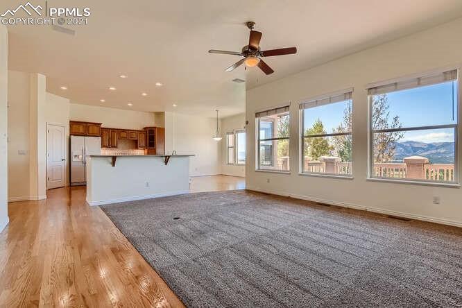 13968 Windy Oaks Road Colorado Springs, CO 80921 - Photo 10 of 34 a view of empty room with wooden floor and window