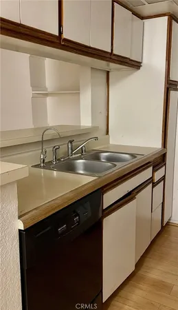 a sink with granite countertop a sink and cabinets