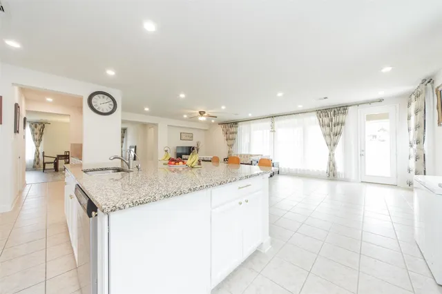 a hall with a sink and a large mirror