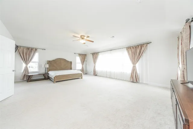 a big room with closet and a chandelier