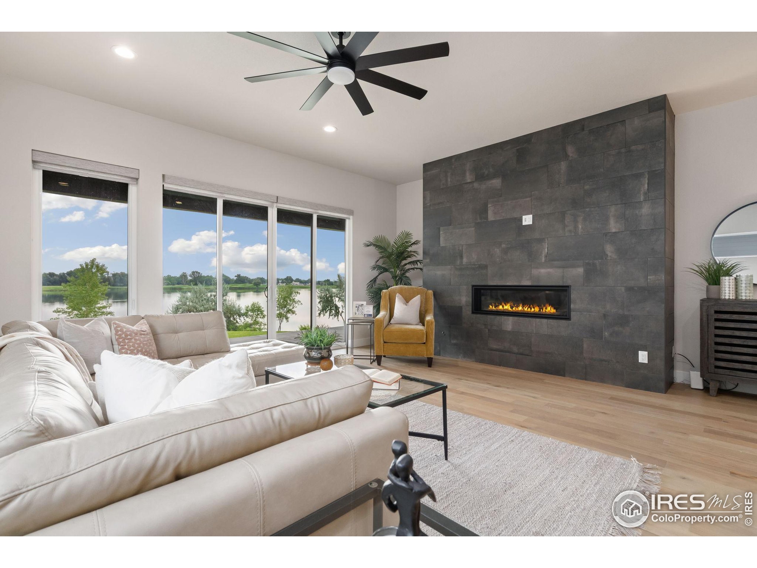 1729 Beachside Drive Windsor, CO 80550 - Photo 14 of 49 a living room with furniture and a flat screen tv