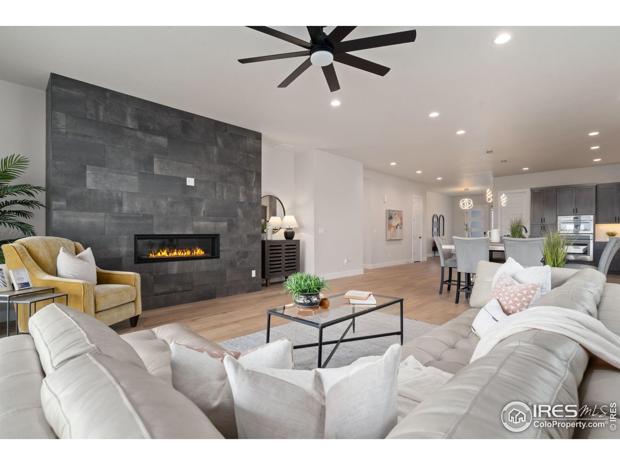 1729 Beachside Drive Windsor, CO 80550 - Photo 17 of 49 a living room with furniture and a fireplace