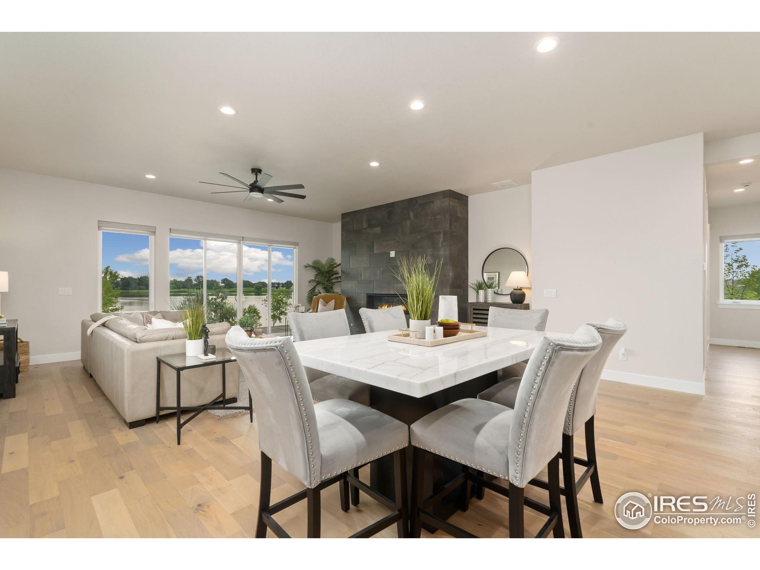 1729 Beachside Drive Windsor, CO 80550 - Photo 18 of 49 a view of a dining room with furniture and a large window
