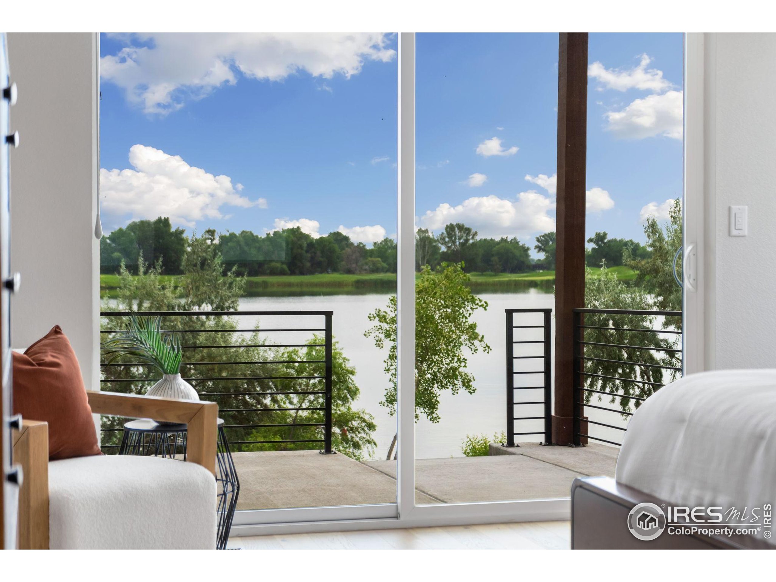 1729 Beachside Drive Windsor, CO 80550 - Photo 20 of 49 a view of a balcony with couches and wooden floor