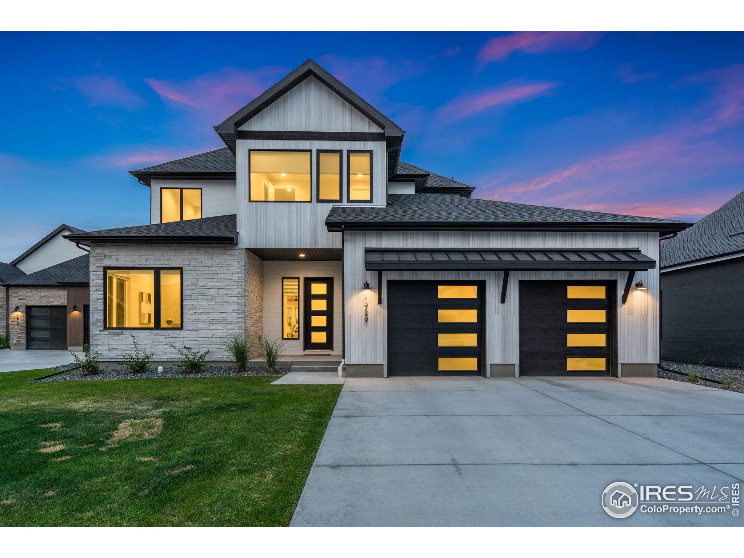 1729 Beachside Drive Windsor, CO 80550 - Photo 2 of 49 a front view of a house with garden