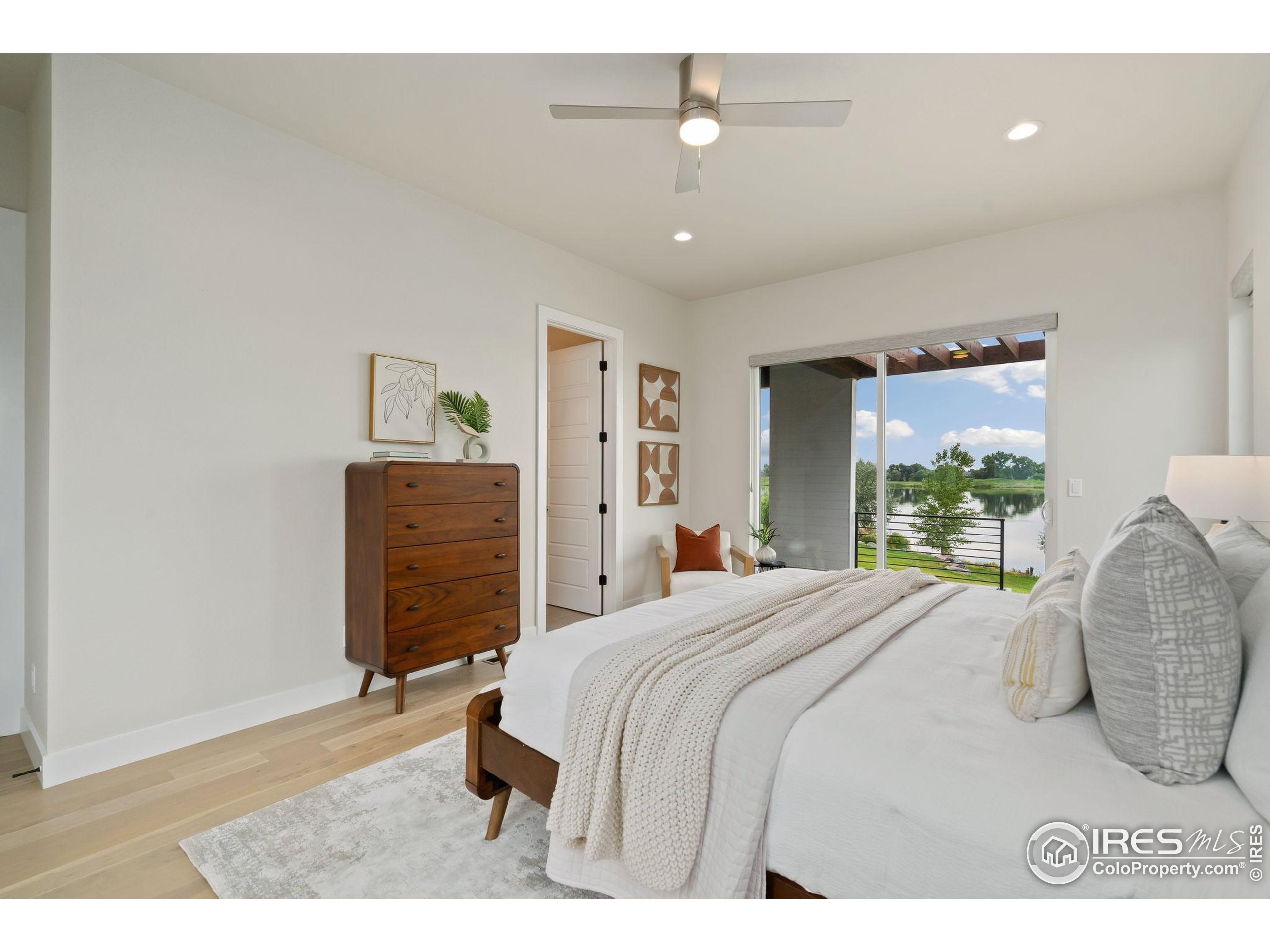 1729 Beachside Drive Windsor, CO 80550 - Photo 21 of 49 a bedroom with a bed and a cabinets