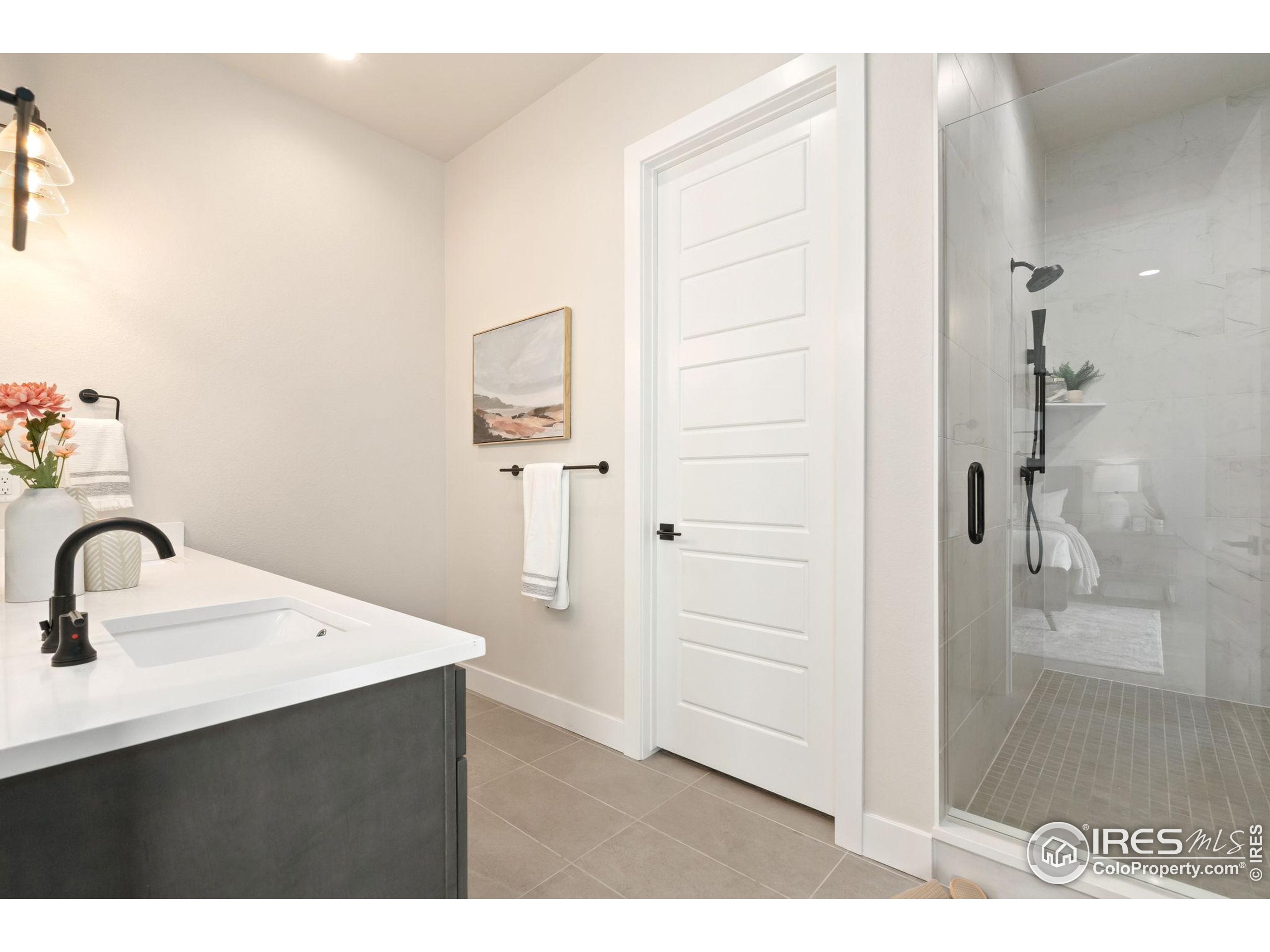 1729 Beachside Drive Windsor, CO 80550 - Photo 23 of 49 a bathroom with a sink and a mirror