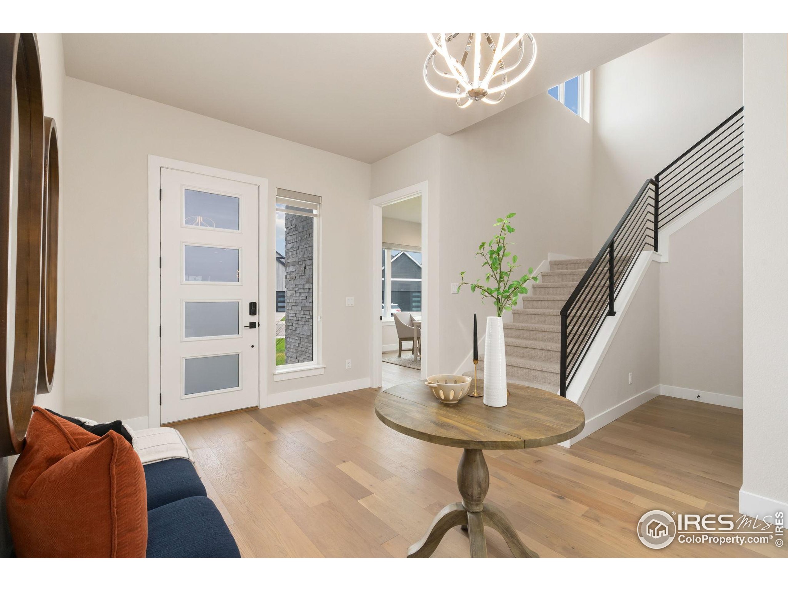 1729 Beachside Drive Windsor, CO 80550 - Photo 26 of 49 a view of an entryway with wooden floor