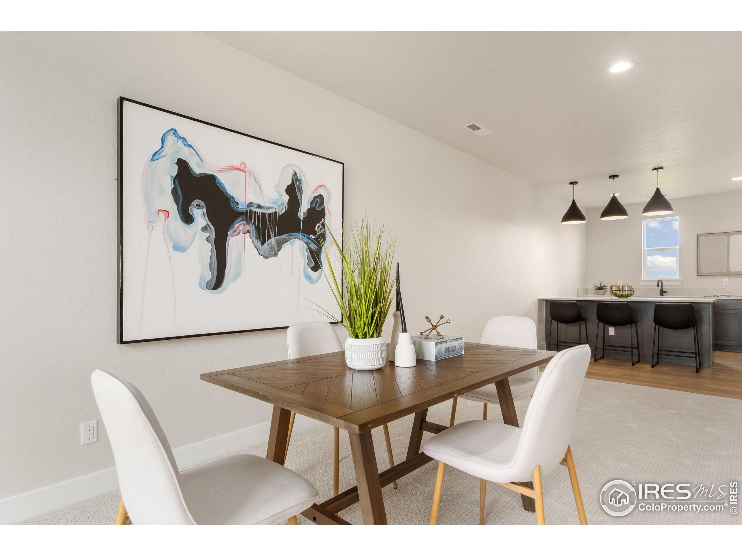 1729 Beachside Drive Windsor, CO 80550 - Photo 28 of 49 a view of a dining room with furniture and wooden floor