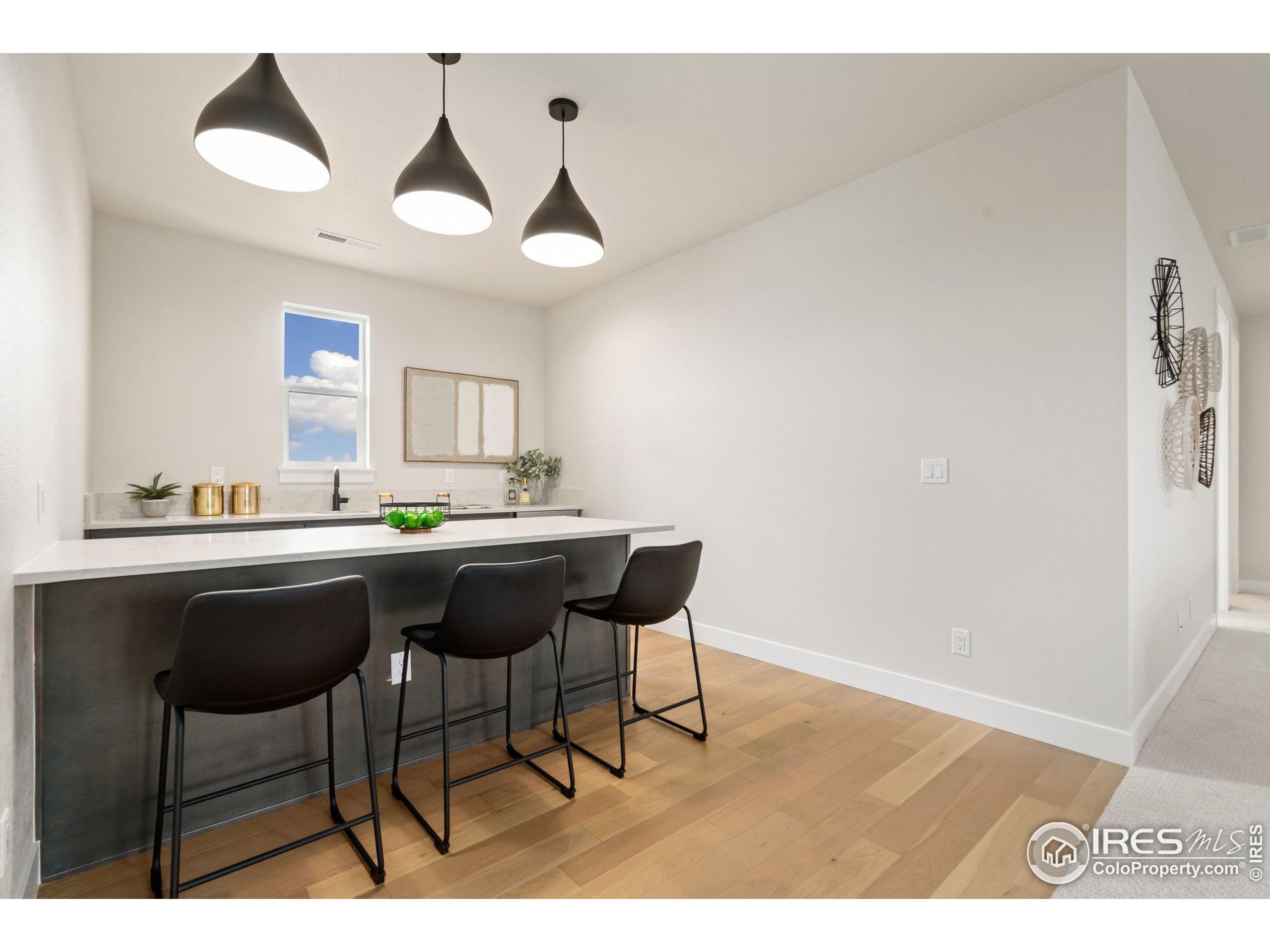 1729 Beachside Drive Windsor, CO 80550 - Photo 29 of 49 a kitchen with a dining table and chairs