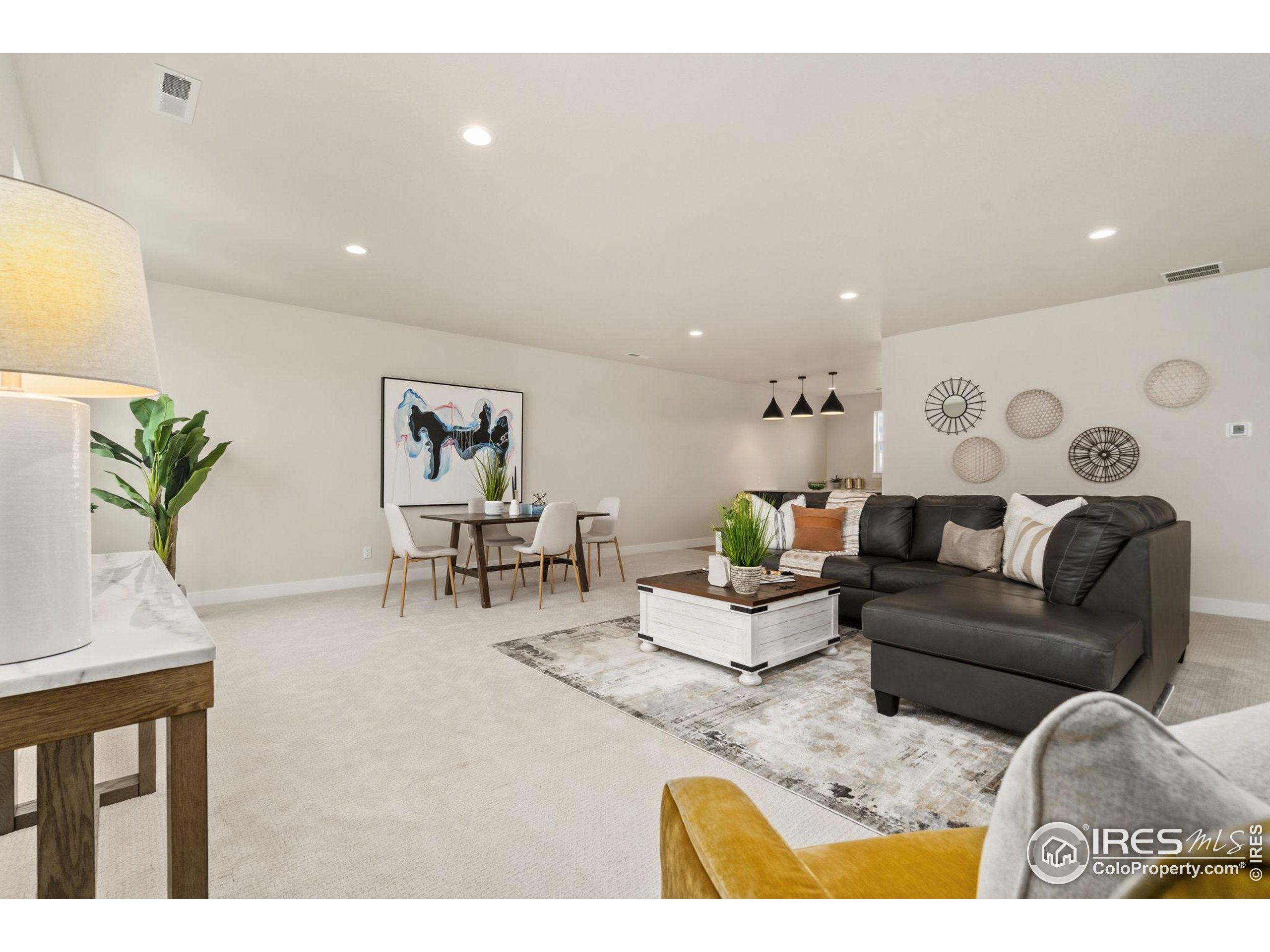 1729 Beachside Drive Windsor, CO 80550 - Photo 31 of 49 a living room with furniture and wooden floor