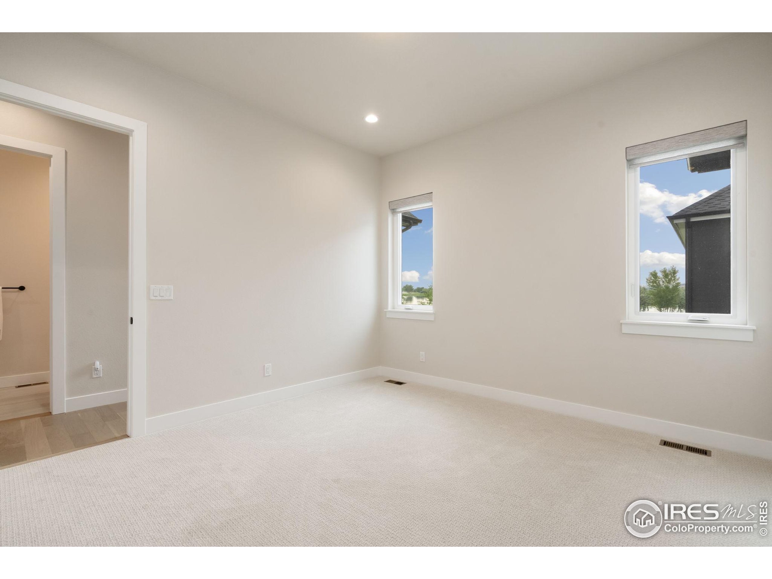 1729 Beachside Drive Windsor, CO 80550 - Photo 34 of 49 an empty room with windows and closet