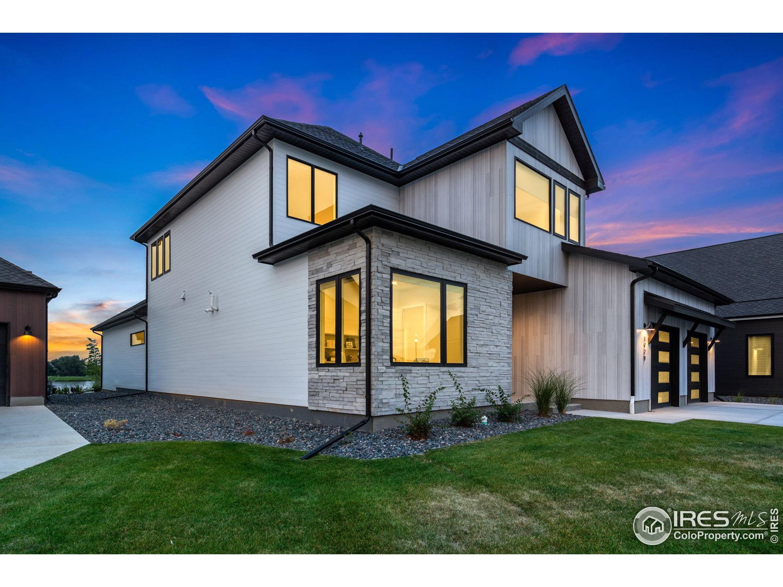 1729 Beachside Drive Windsor, CO 80550 - Photo 42 of 49 a view of front of house with a yard
