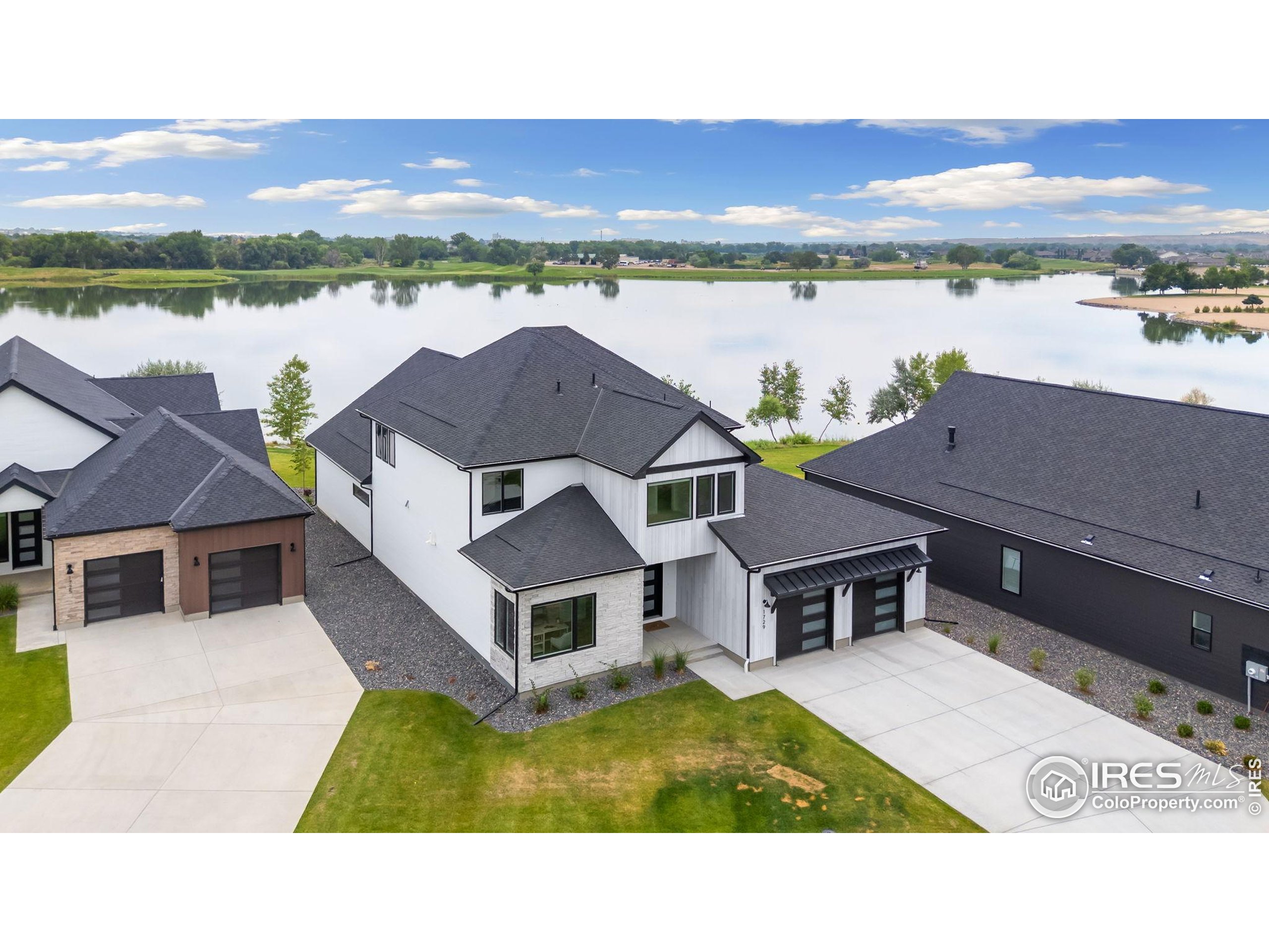 1729 Beachside Drive Windsor, CO 80550 - Photo 45 of 49 a aerial view of a house with a lake view