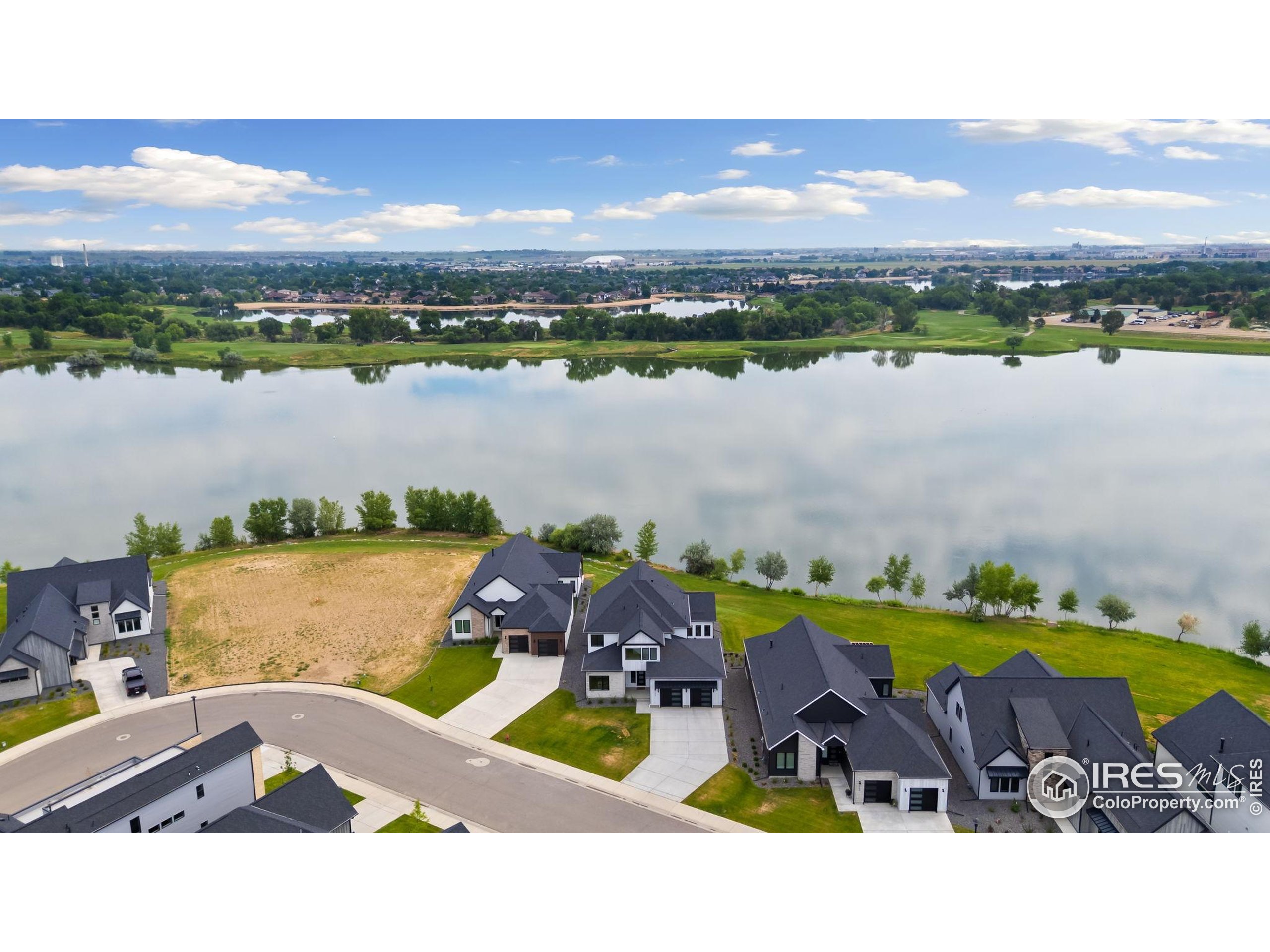 1729 Beachside Drive Windsor, CO 80550 - Photo 48 of 49 a swimming pool with outdoor seating and a lake view