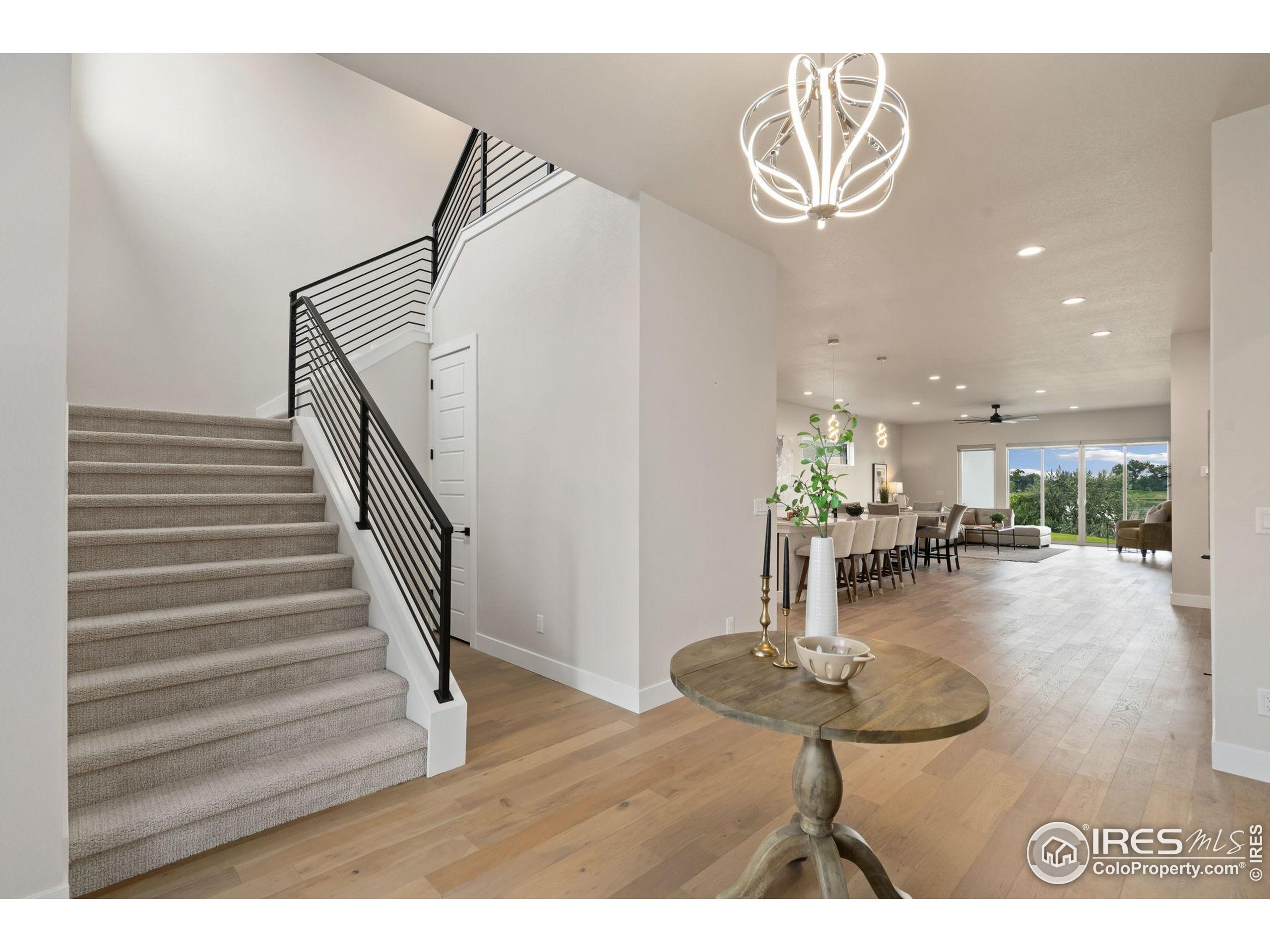 1729 Beachside Drive Windsor, CO 80550 - Photo 5 of 49 a dining room with furniture and wooden floor
