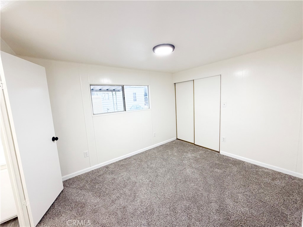 104 Sir Tristram Drive, Unit 104 Riverside, CA 92507 - Photo 13 of 26 a view of an empty room with a window