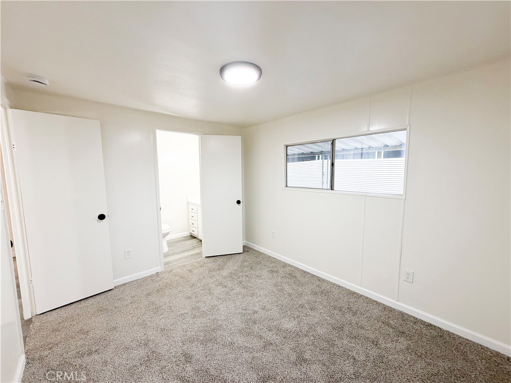 104 Sir Tristram Drive, Unit 104 Riverside, CA 92507 - Photo 14 of 26 an empty room with windows and closet