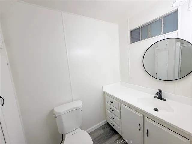 a bathroom with a sink mirror vanity and toilet