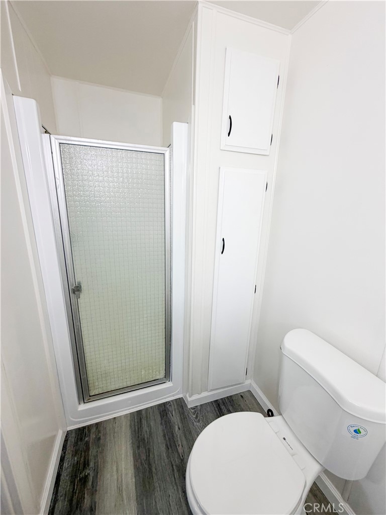 104 Sir Tristram Drive, Unit 104 Riverside, CA 92507 - Photo 18 of 26 a bathroom with a toilet and a shower