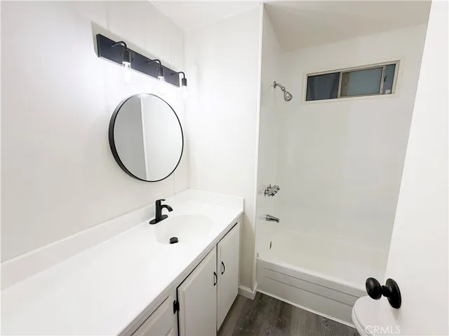 a white toilet sitting next to a white sink