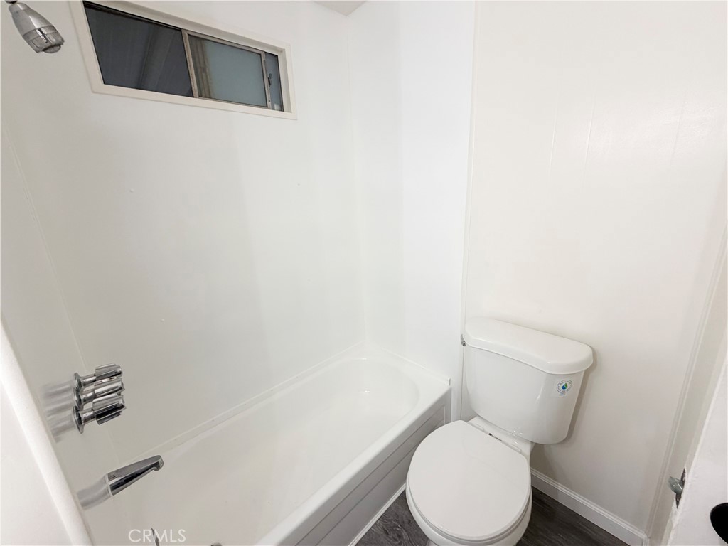 104 Sir Tristram Drive, Unit 104 Riverside, CA 92507 - Photo 25 of 26 a white toilet sitting next to a white sink