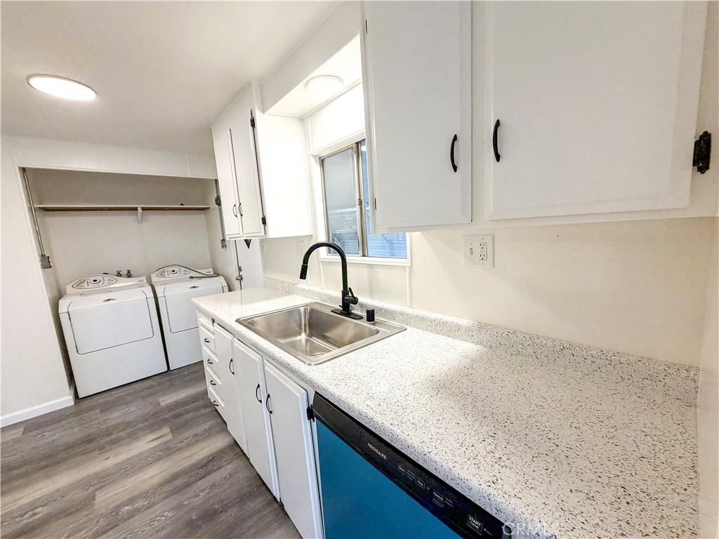 104 Sir Tristram Drive, Unit 104 Riverside, CA 92507 - Photo 6 of 26 a kitchen with a sink and a stove top oven