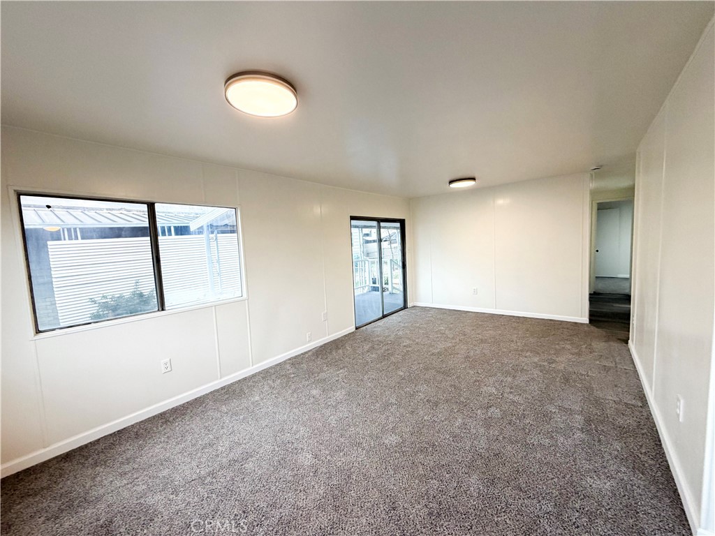 104 Sir Tristram Drive, Unit 104 Riverside, CA 92507 - Photo 7 of 26 an empty room with windows and entrance