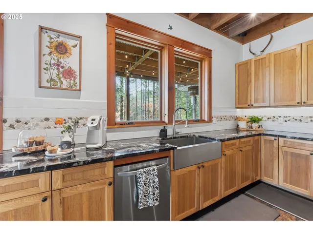 a kitchen with granite countertop a sink stove and cabinets