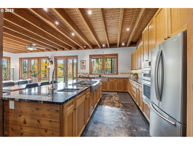 a kitchen with stainless steel appliances granite countertop a sink stove and refrigerator