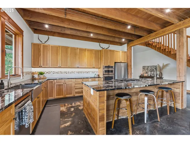 a kitchen with stainless steel appliances granite countertop a sink and cabinets