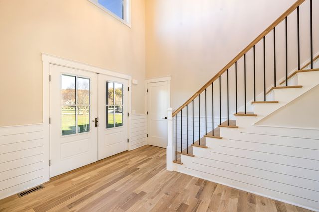 a view of an entryway with wooden floor