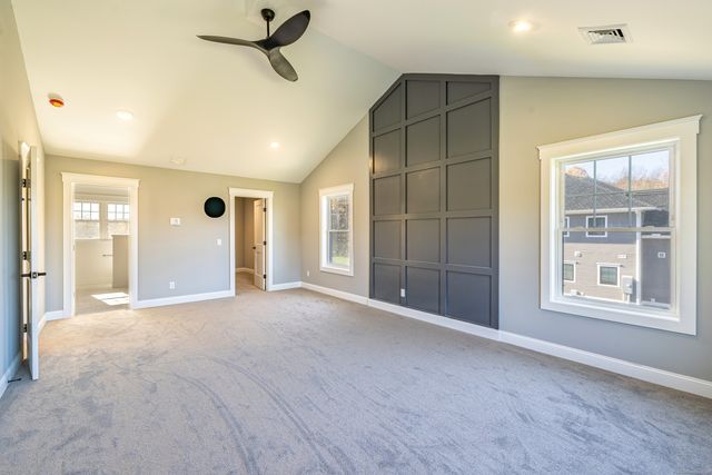 an empty room with windows and closet