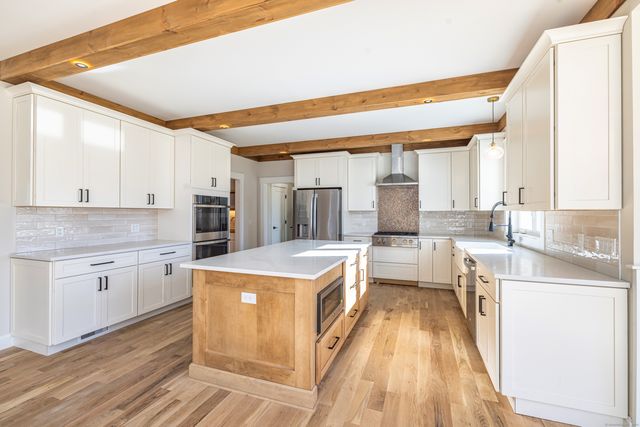 a kitchen with a stove a sink and a refrigerator