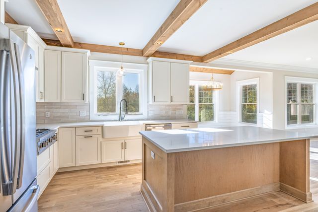 a kitchen with a sink stove and cabinets