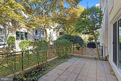 a view of a refrigerator in kitchen and an empty room