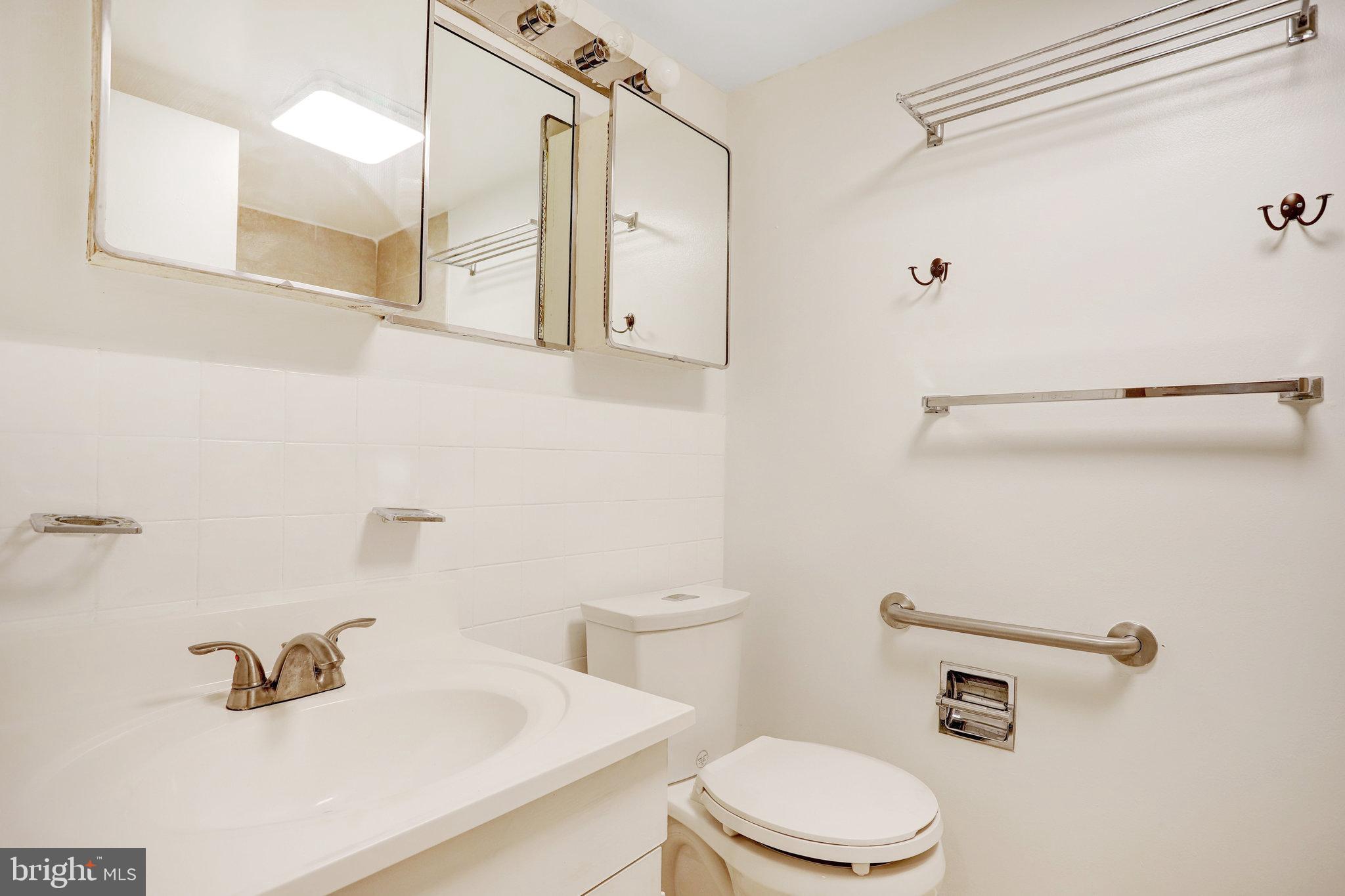 42 G Street Southwest Washington, DC 20024 - Photo 35 of 54 a bathroom with a sink a toilet and shower curtain