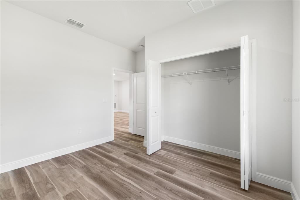 5217 Southwest 165th St Road Ocala, FL 34473 - Photo 16 of 35 a view of empty room with wooden floor