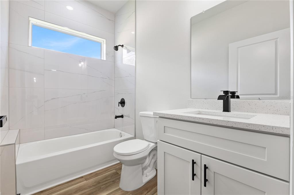 5217 Southwest 165th St Road Ocala, FL 34473 - Photo 17 of 35 a bathroom with a sink a toilet and a bathtub