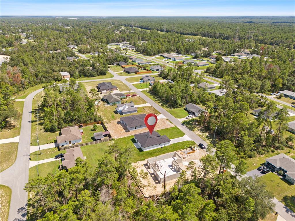5217 Southwest 165th St Road Ocala, FL 34473 - Photo 34 of 35 an aerial view of residential houses with outdoor space and trees