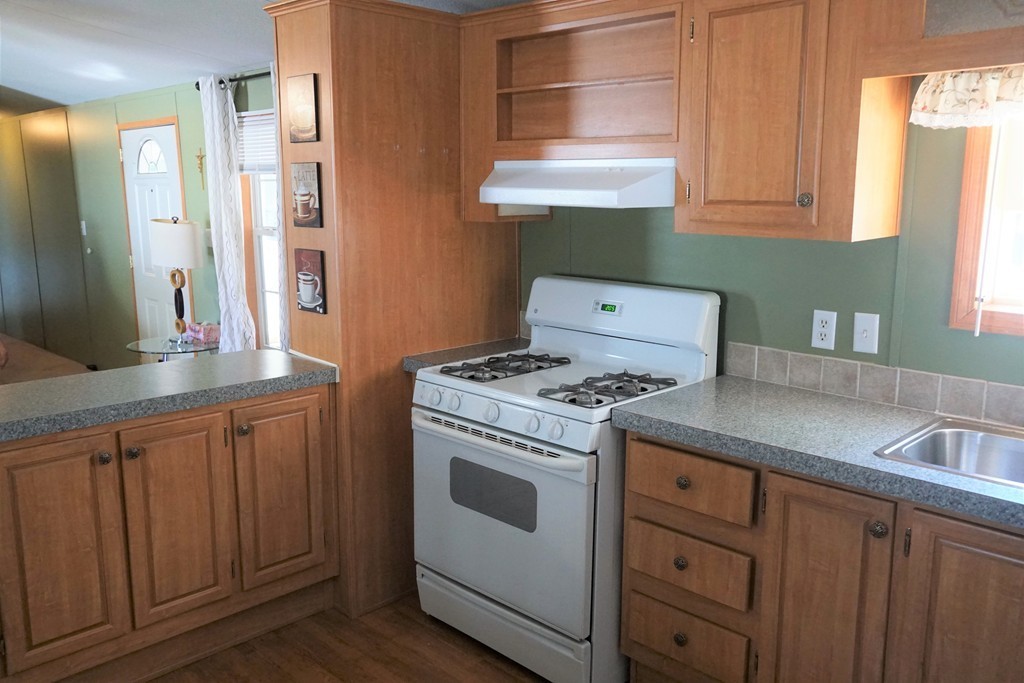 62 Cypress Road Taunton, MA 02780 - Photo 12 of 26 a kitchen with a stove top oven cabinets and a window