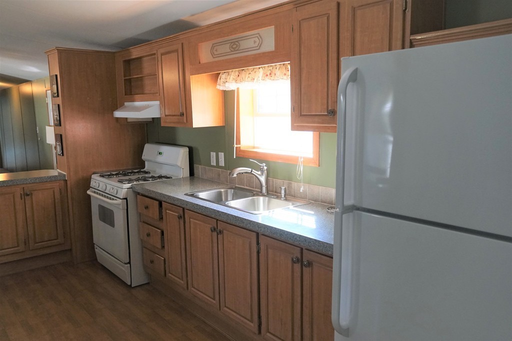 62 Cypress Road Taunton, MA 02780 - Photo 13 of 26 a kitchen with a sink a window and stainless steel appliances