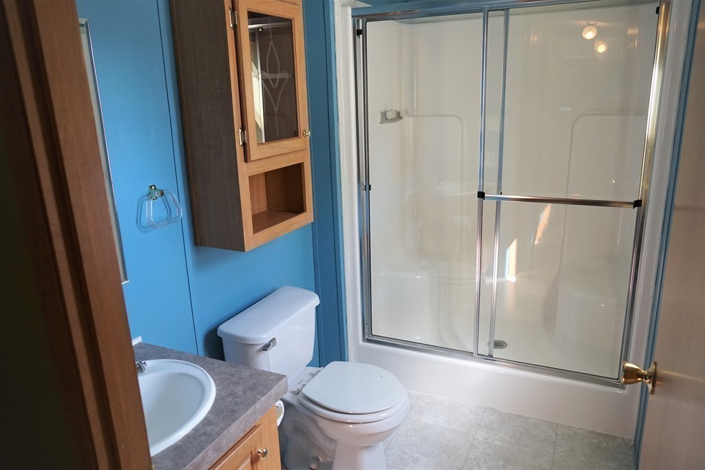 62 Cypress Road Taunton, MA 02780 - Photo 16 of 26 a white toilet sitting next to a bathroom sink