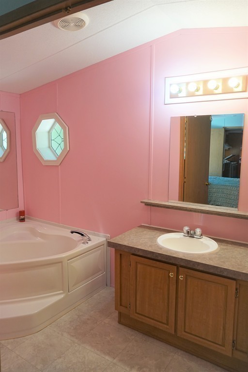 62 Cypress Road Taunton, MA 02780 - Photo 18 of 26 a bathroom with a sink a vanity and a mirror