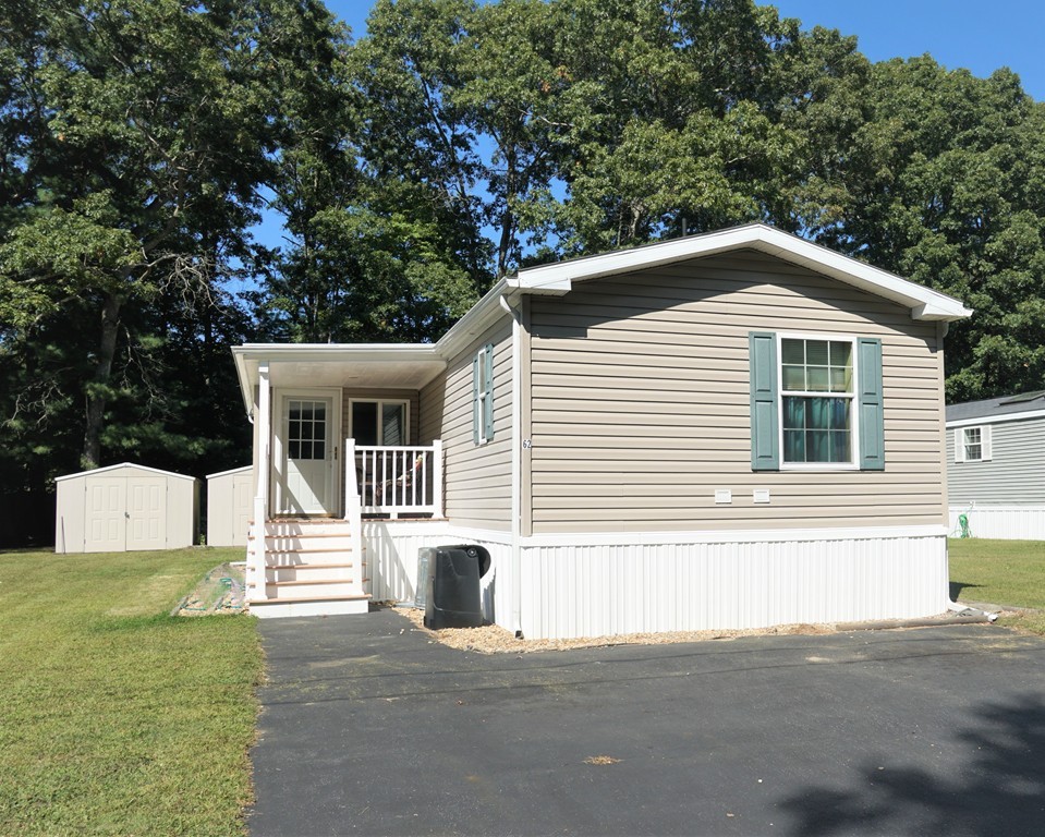 62 Cypress Road Taunton, MA 02780 - Photo 2 of 26 a front view of a house with a garage